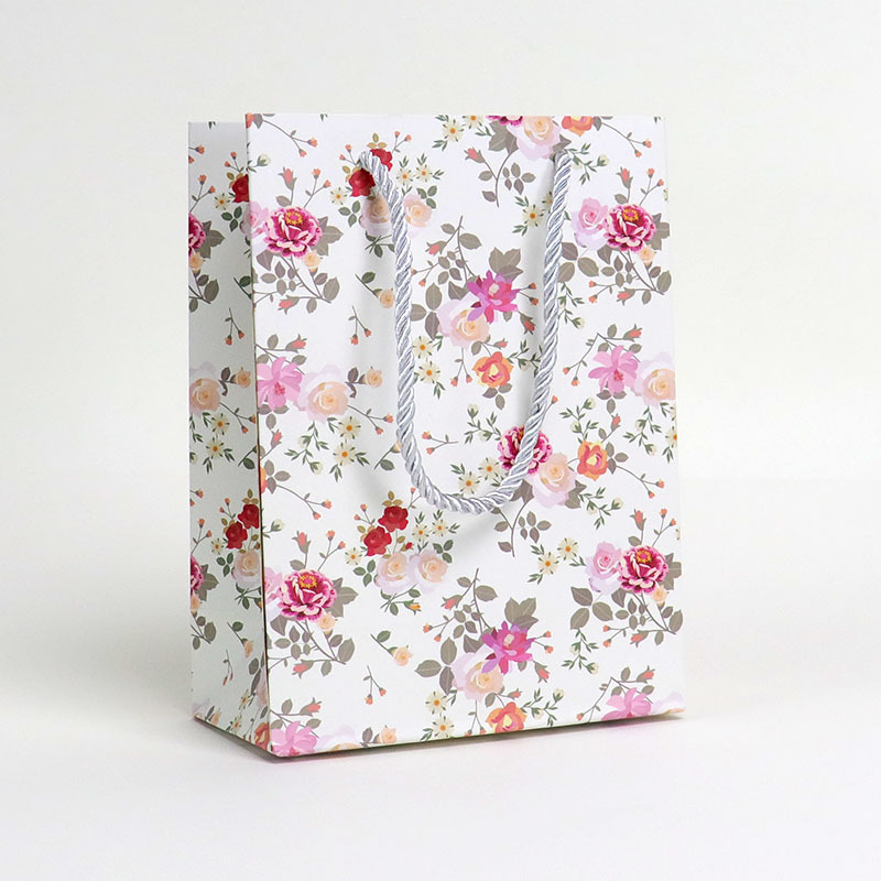 Wholesale minimalist floral-print paper bags  customizable with logos; small-sized shopping bags for gifts and souvenirs.
