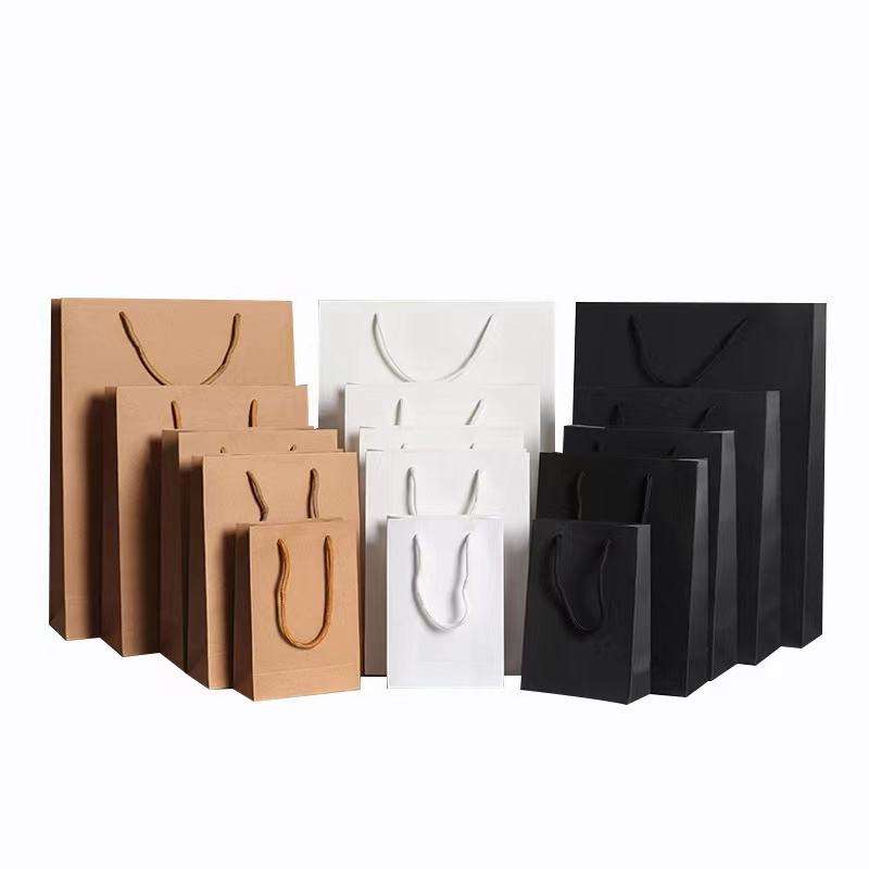 Factory-customized kraft paper bags with handles; color options available.